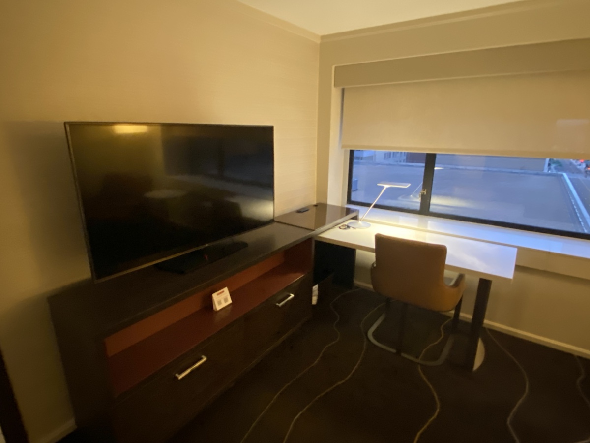 a room with a desk and a tv