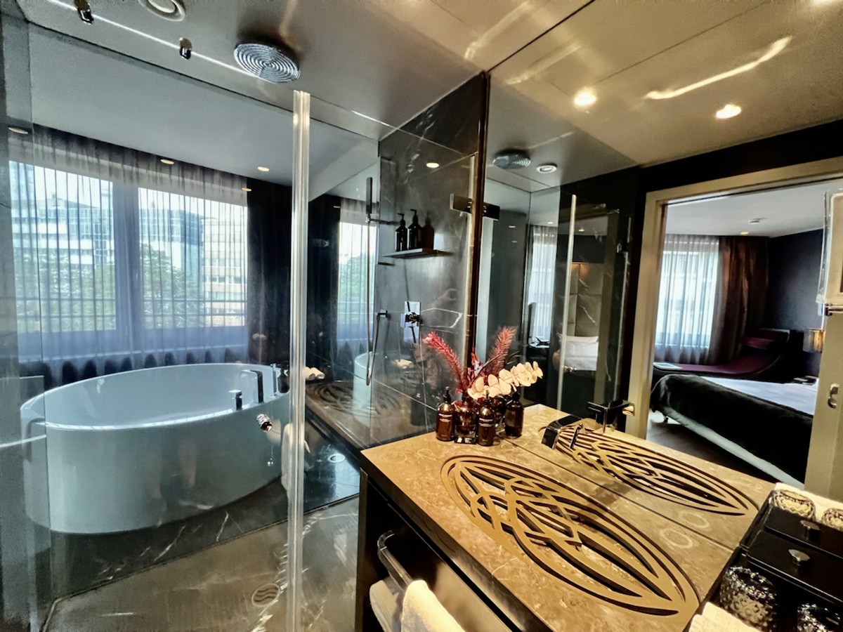 a bathroom with a glass shower and a tub