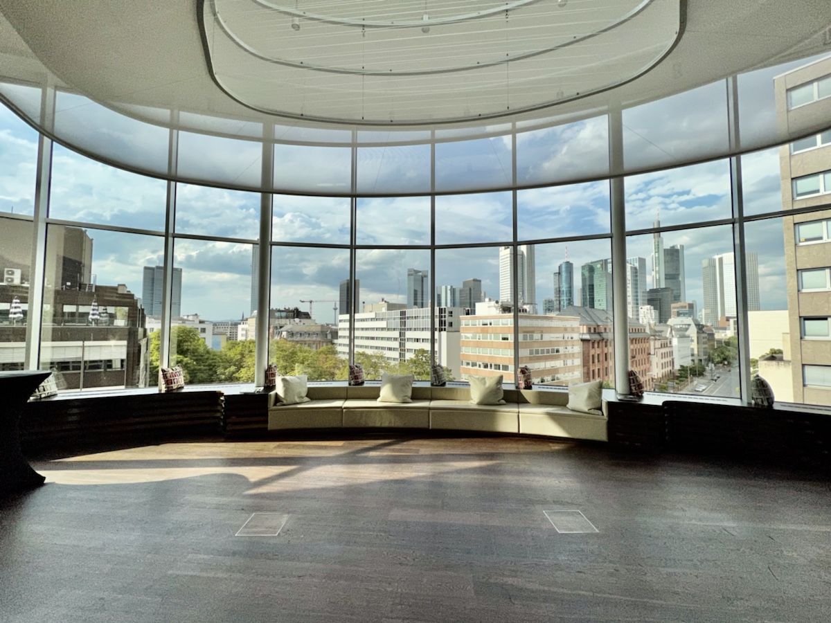 a large room with a large window and a city view