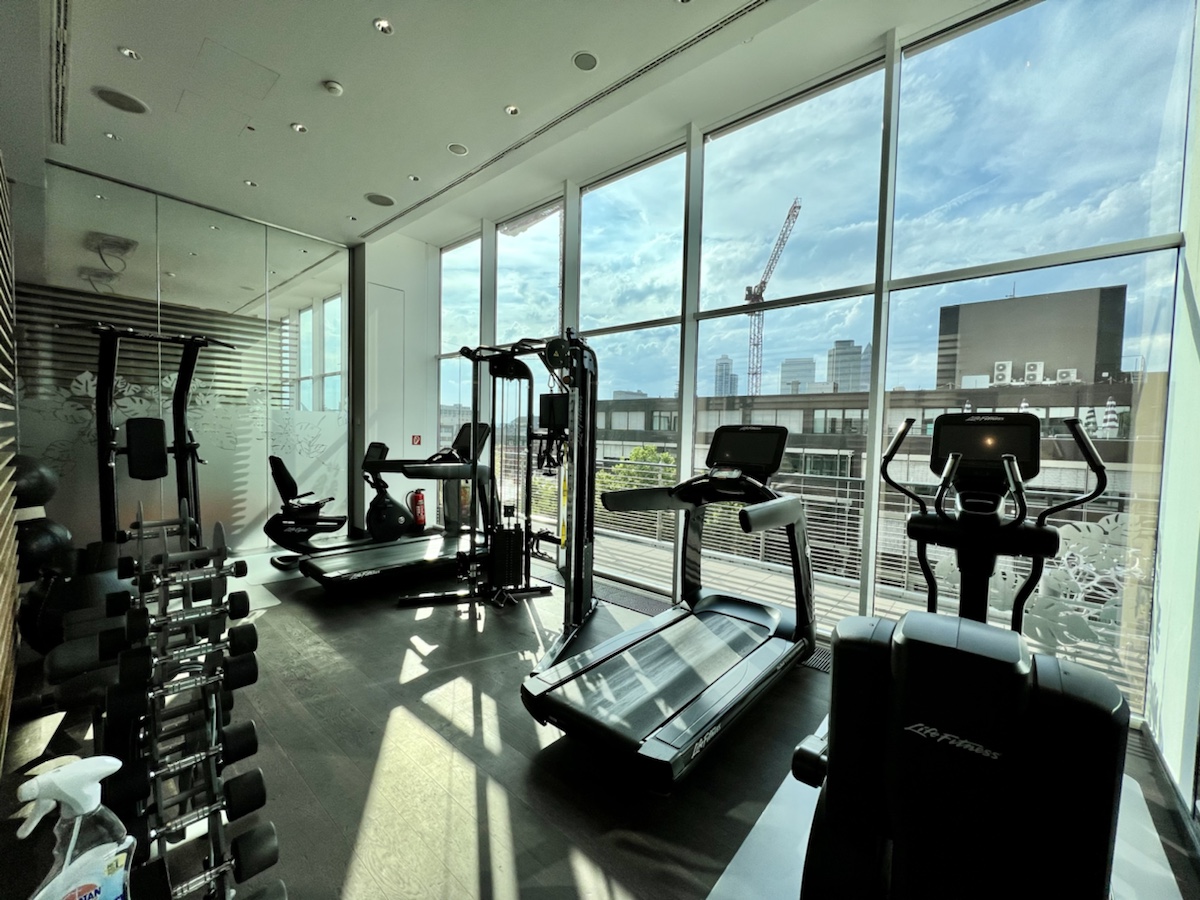 a room with exercise equipment and windows
