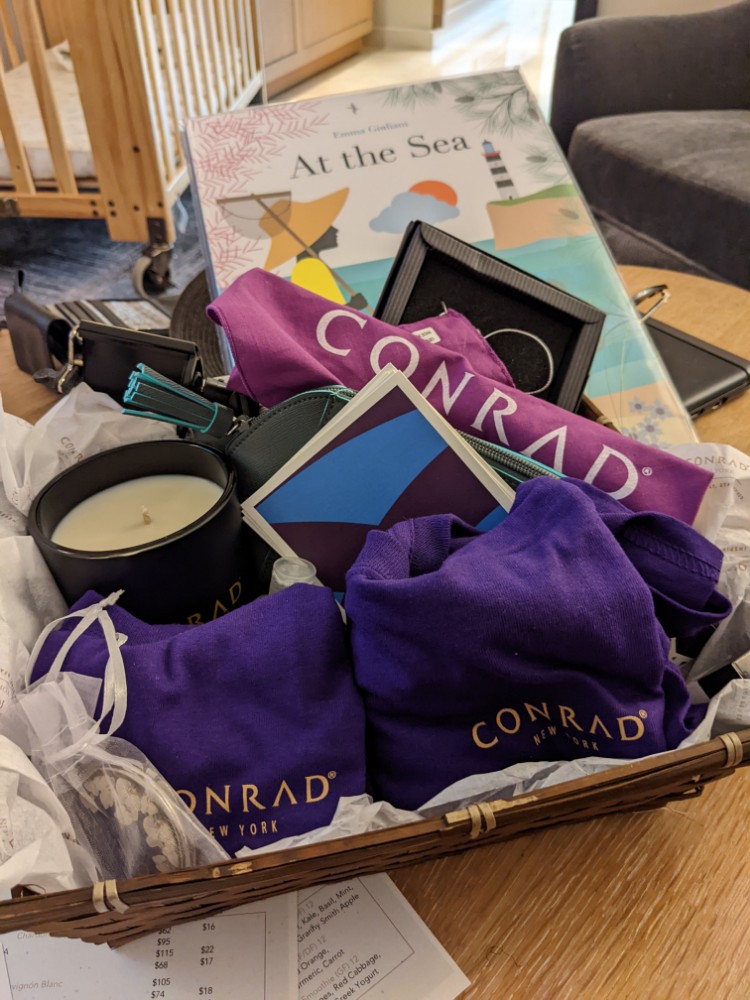 a basket of purple clothing and a candle