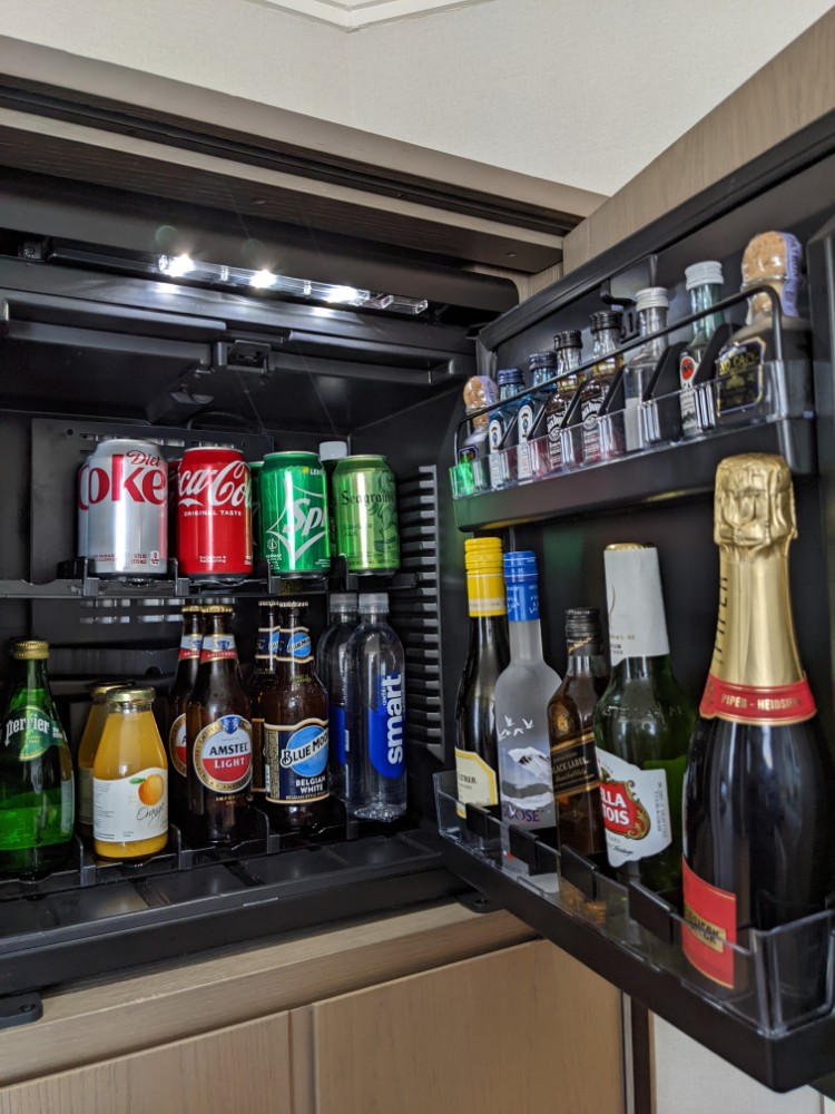 a refrigerator with bottles of alcohol