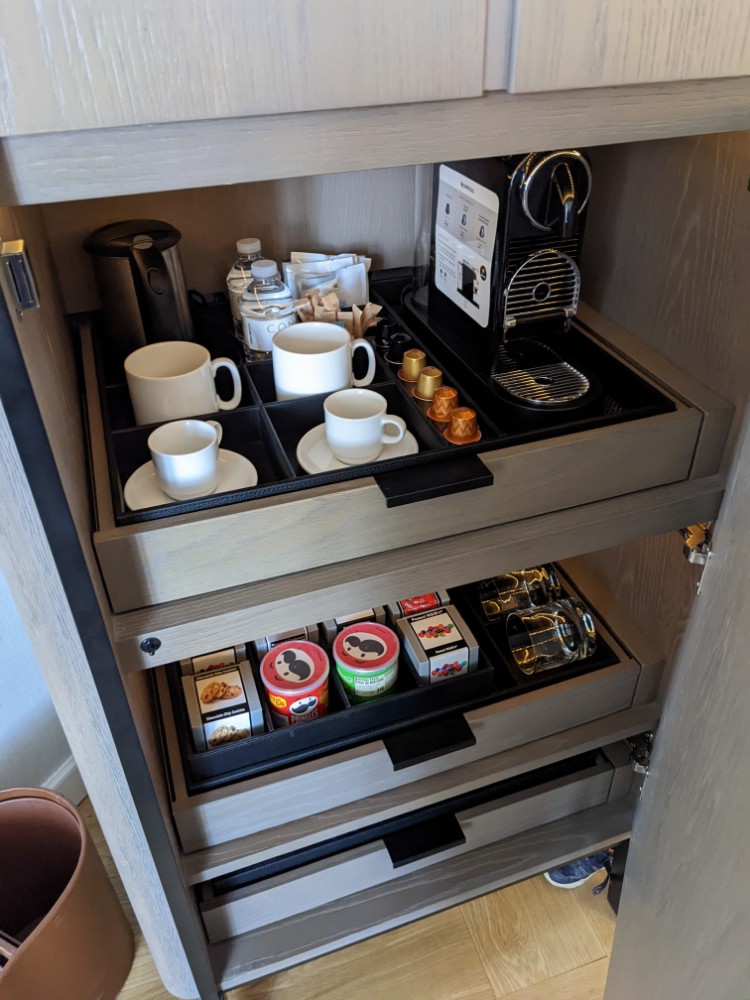 a shelf with coffee and tea cups