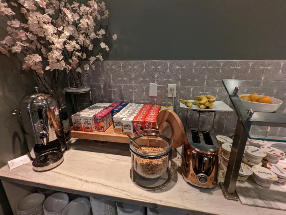 a breakfast buffet with cereals and coffee maker