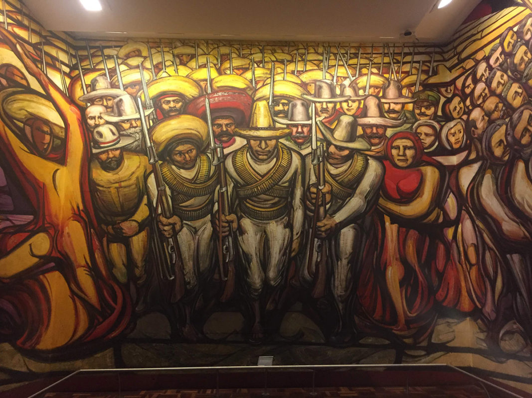 a mural of a group of people holding weapons