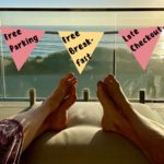 a person's feet on a couch with a flag from a balcony