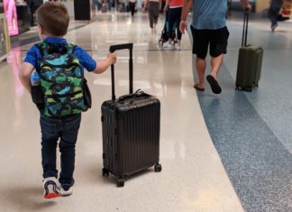 a child pulling a suitcase