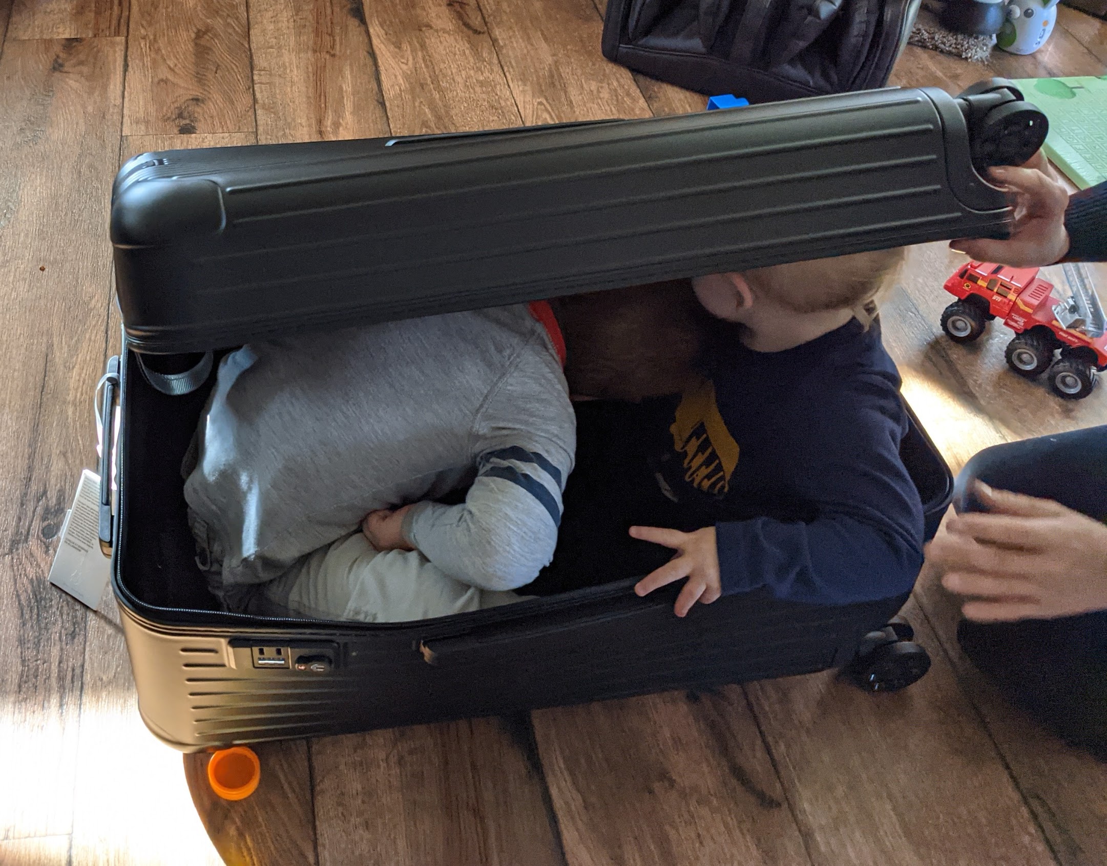two children inside a suitcase