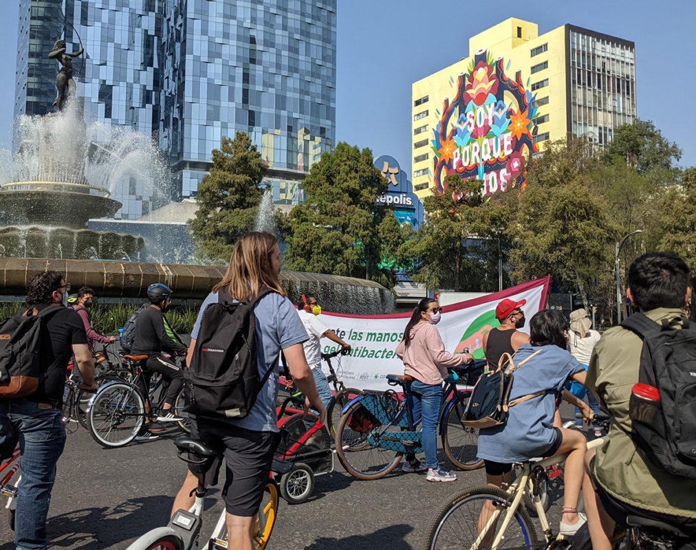 a group of people riding bicycles in a city