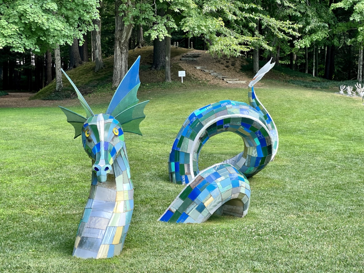 a statue of a dragon and a dragon in a park