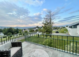 a balcony with a view of a town and houses