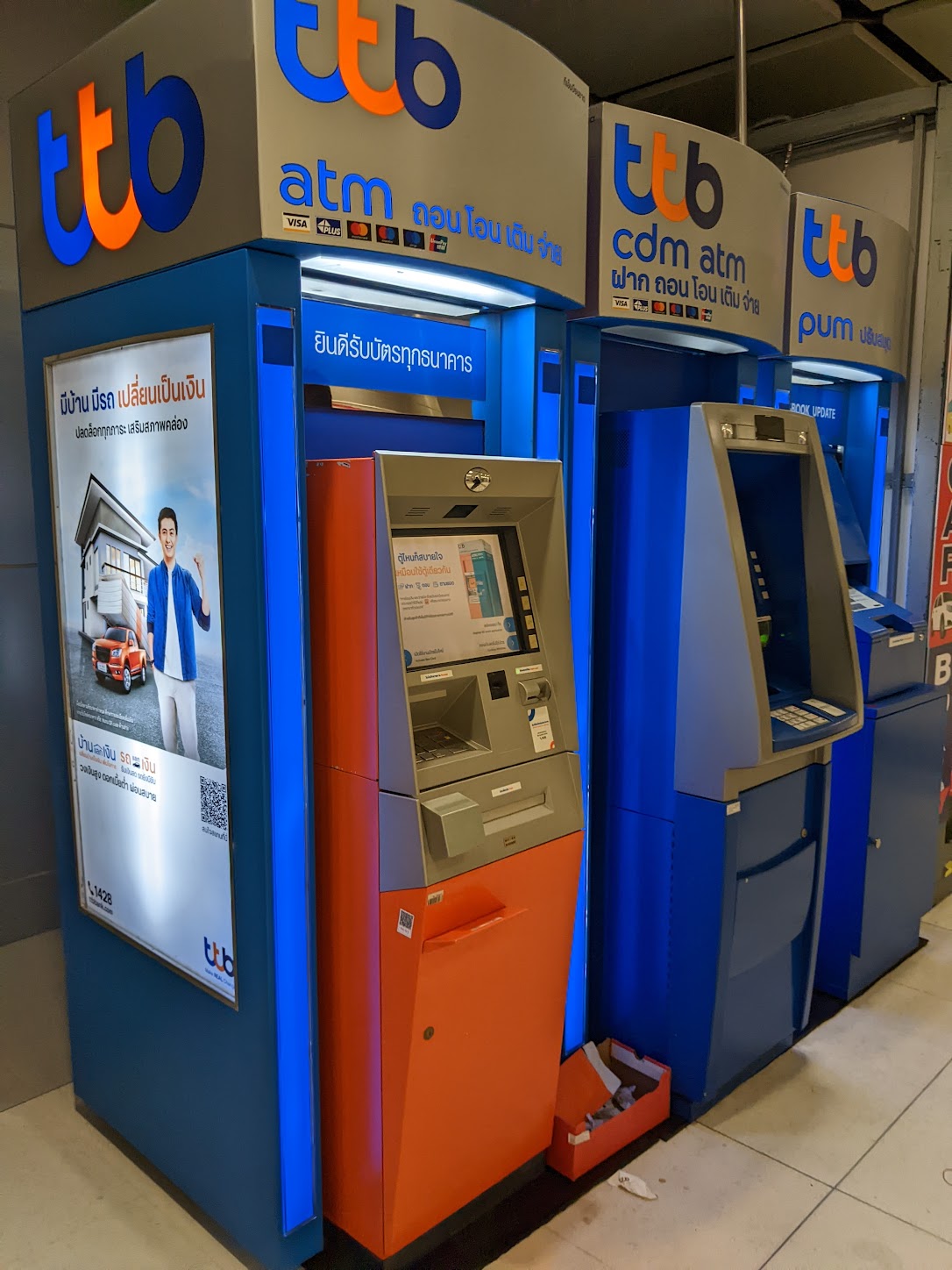 a group of blue and orange atm machines