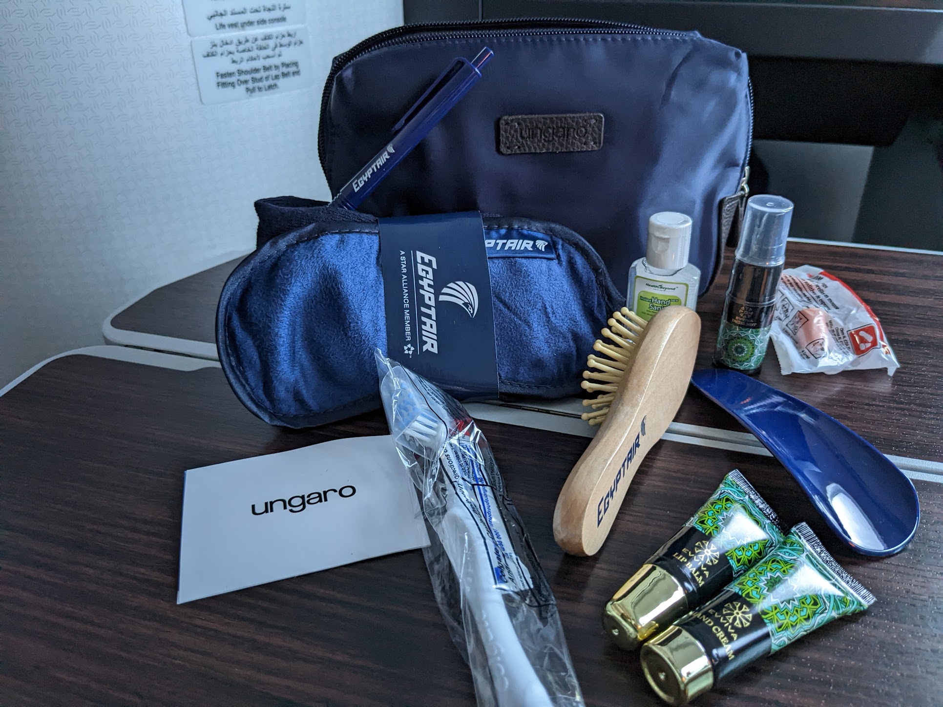 a blue bag with a brush and other items on a table