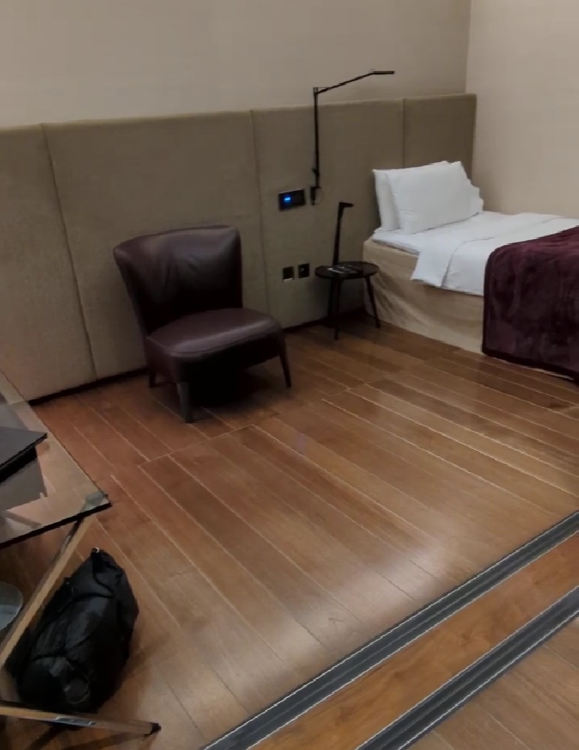 a room with a bed and a chair