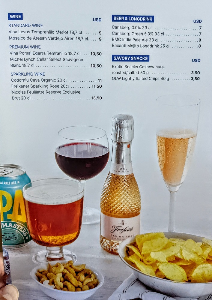 a menu with a bottle of wine and a bowl of chips
