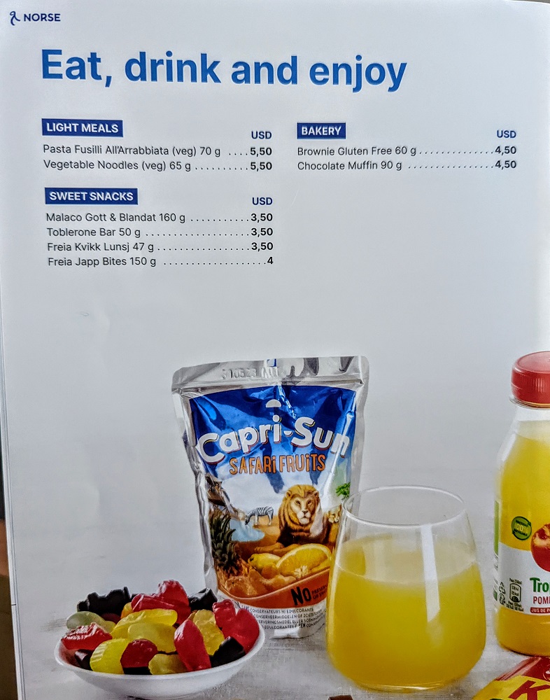 a menu with a glass of juice and a bag of fruit