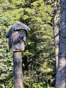 a wood carving of a face on a tree stump