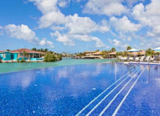 a swimming pool with a body of water and buildings