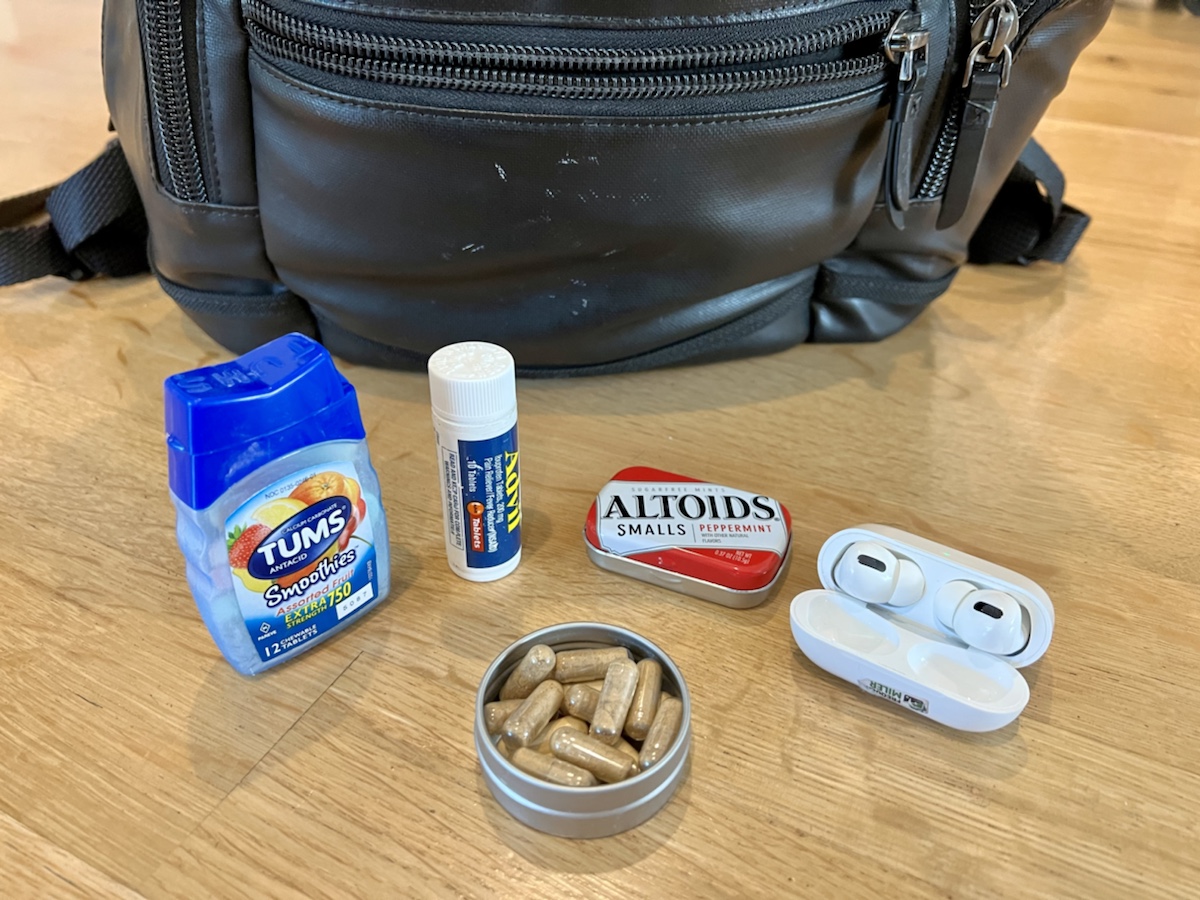 a group of pills and a container of pills on a table