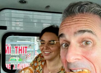 a man and woman eating bread in a van