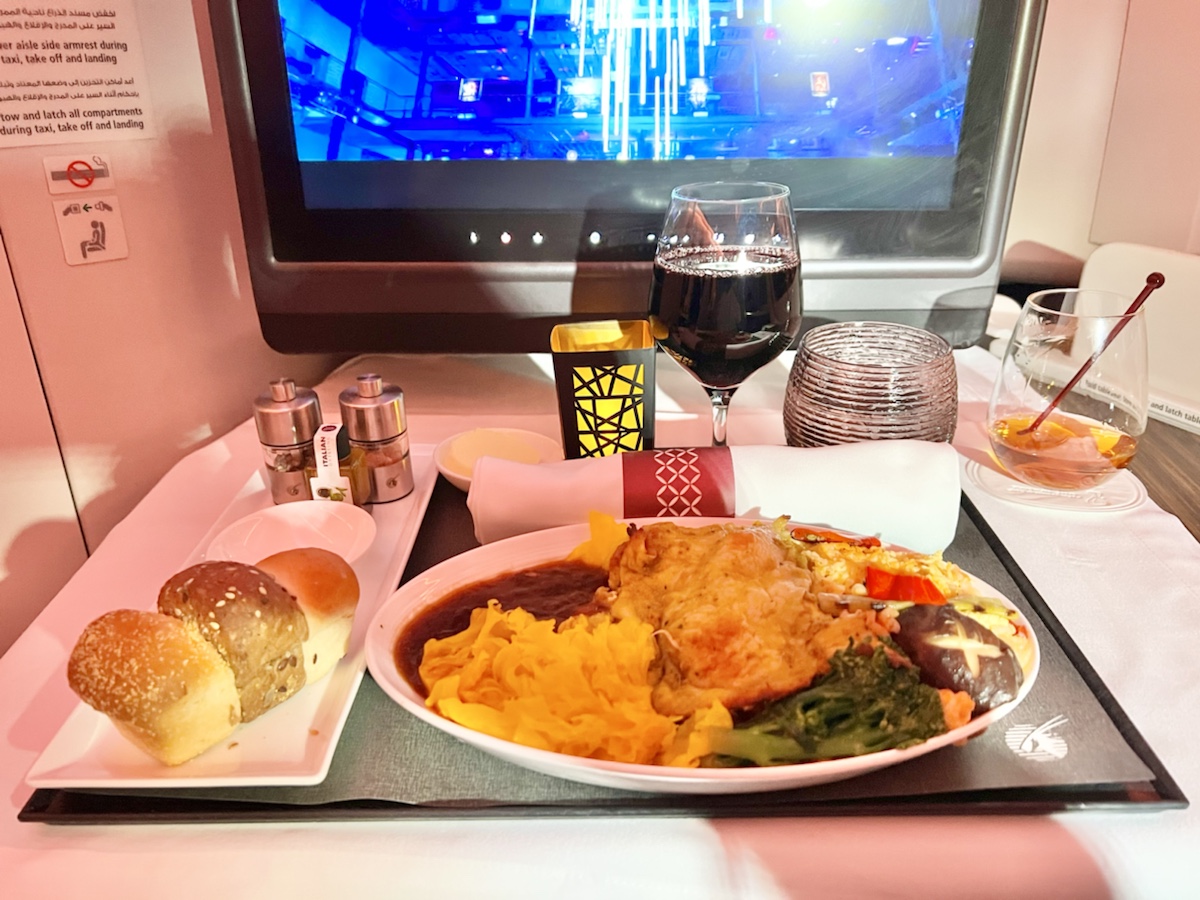 a plate of food on a tray with a television