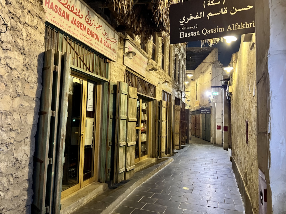 a narrow alleyway with signs and signs on the side