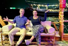 a man and woman sitting on a couch on a boat