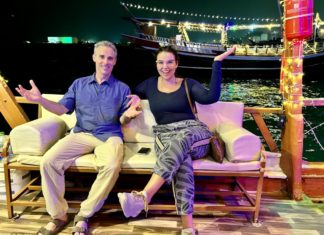 a man and woman sitting on a couch on a boat