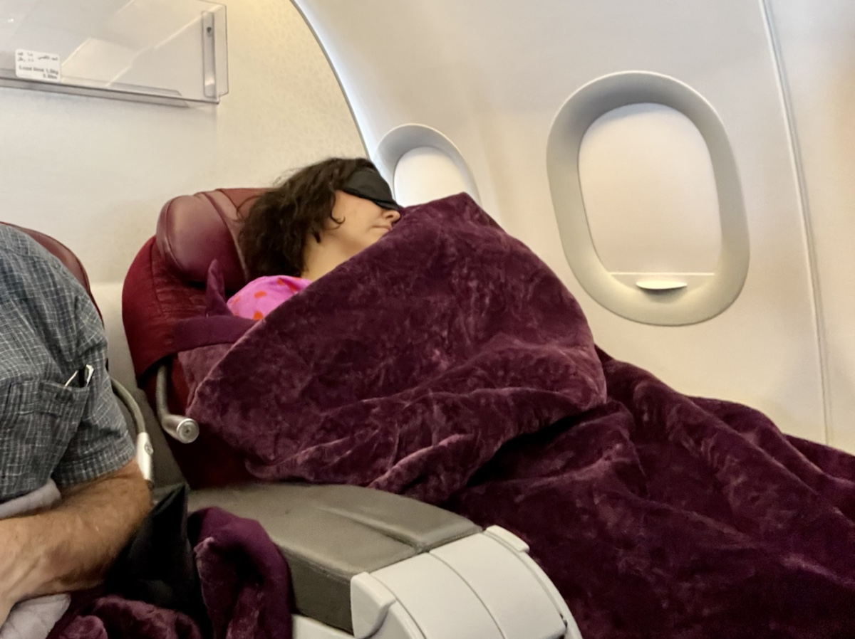 a woman sleeping in an airplane