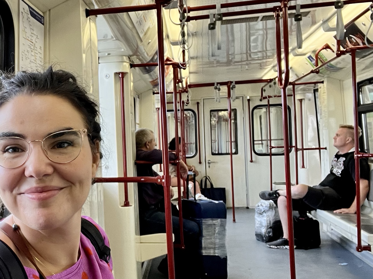 a woman taking a selfie in a train