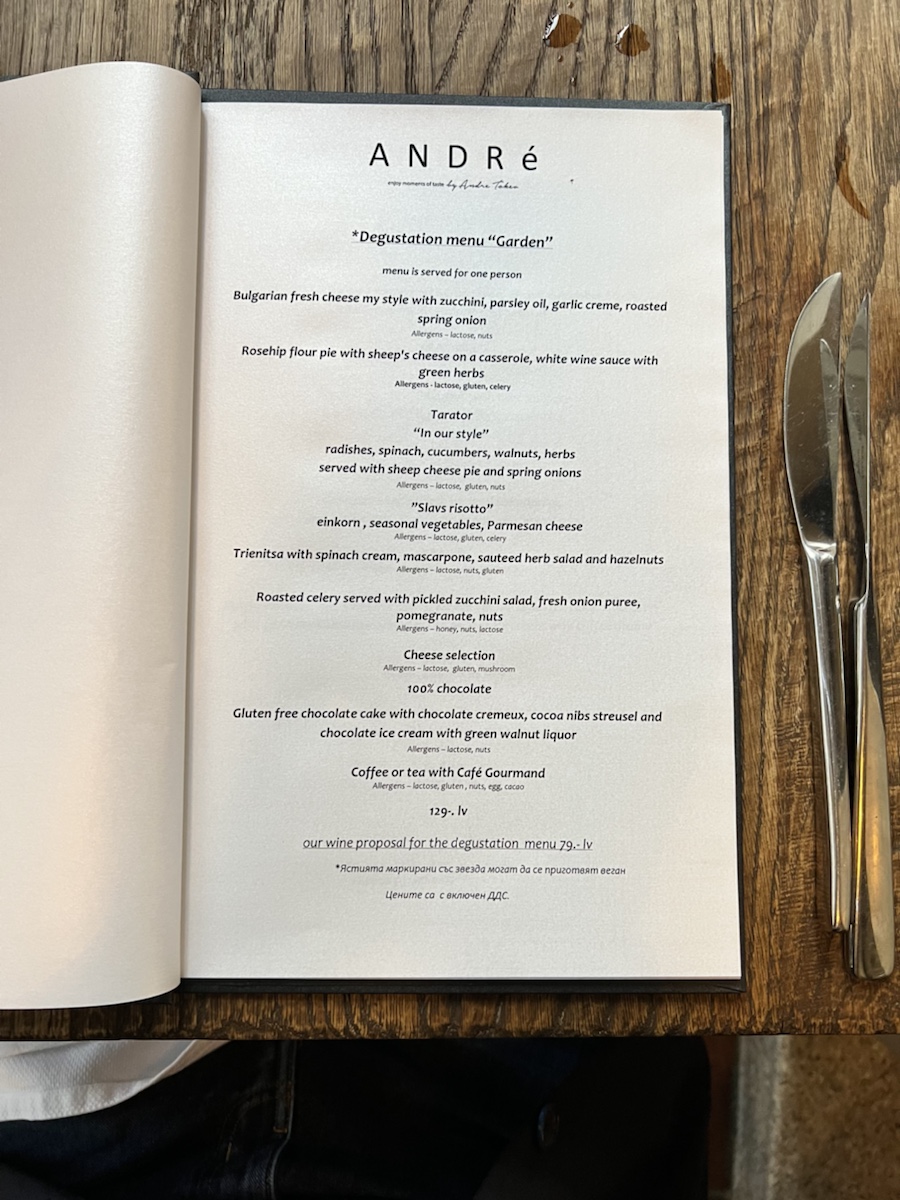 a menu on a table with a knife and fork