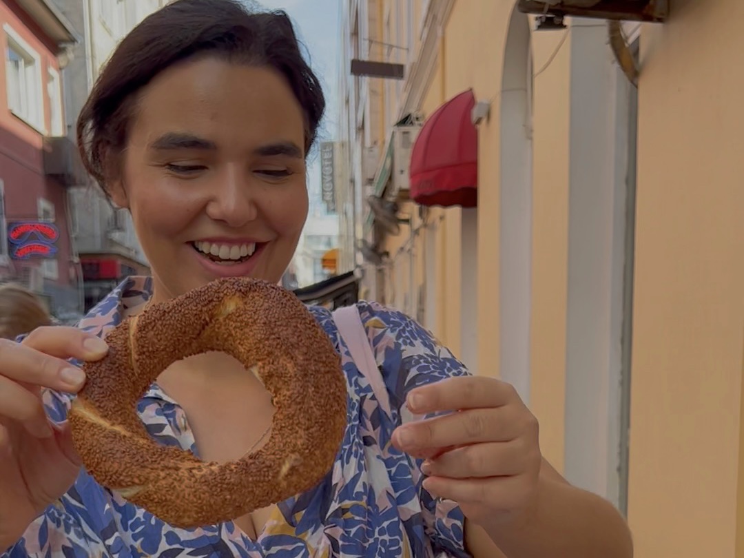 a woman holding a bagel