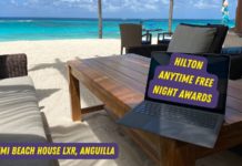 Hilton free weekend nights become anytime nights! a laptop on a table on a beach