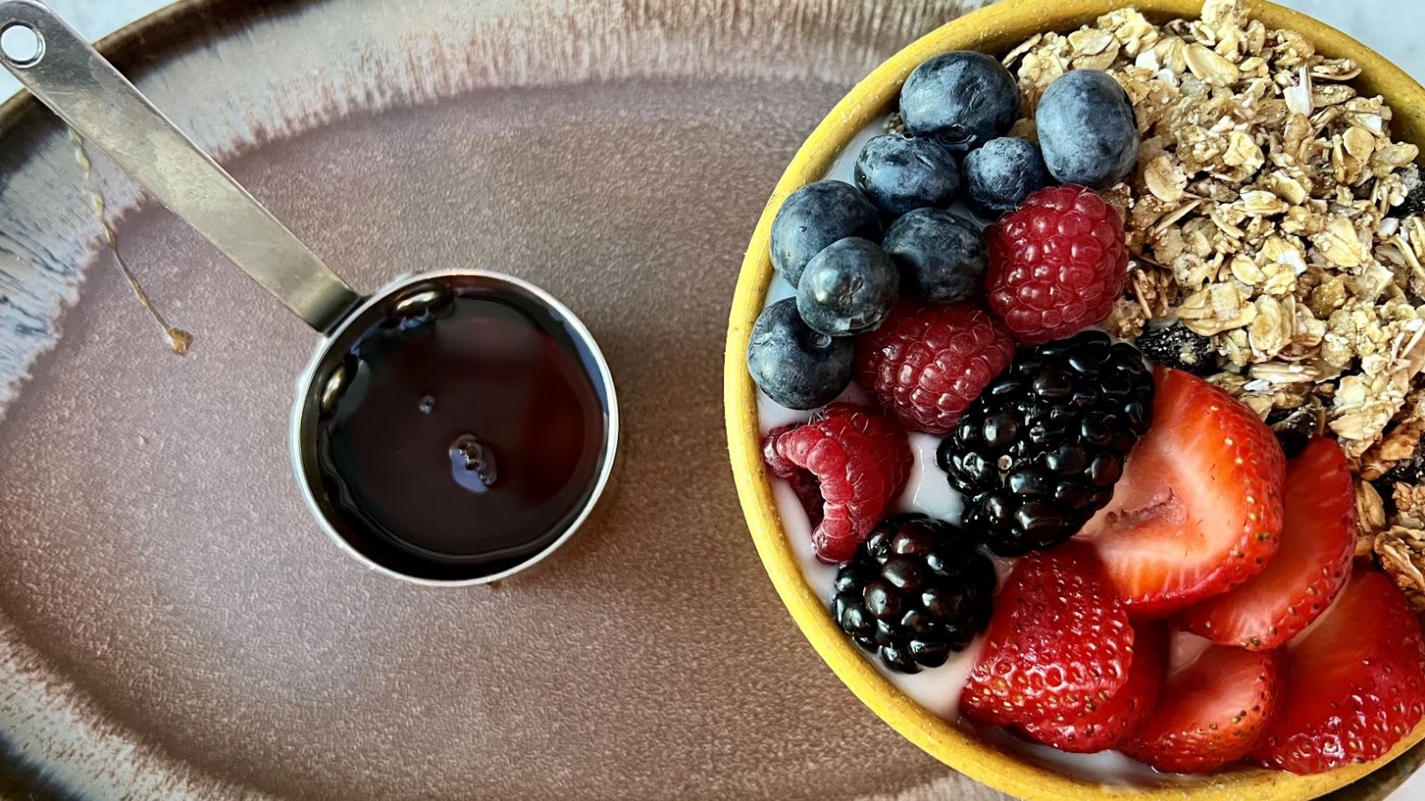 a bowl of fruit and a cup of liquid