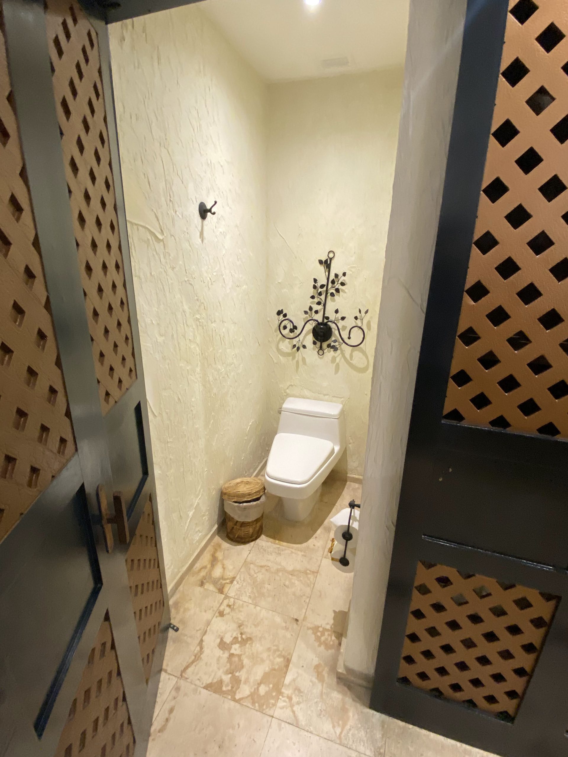 a bathroom with a toilet and a door