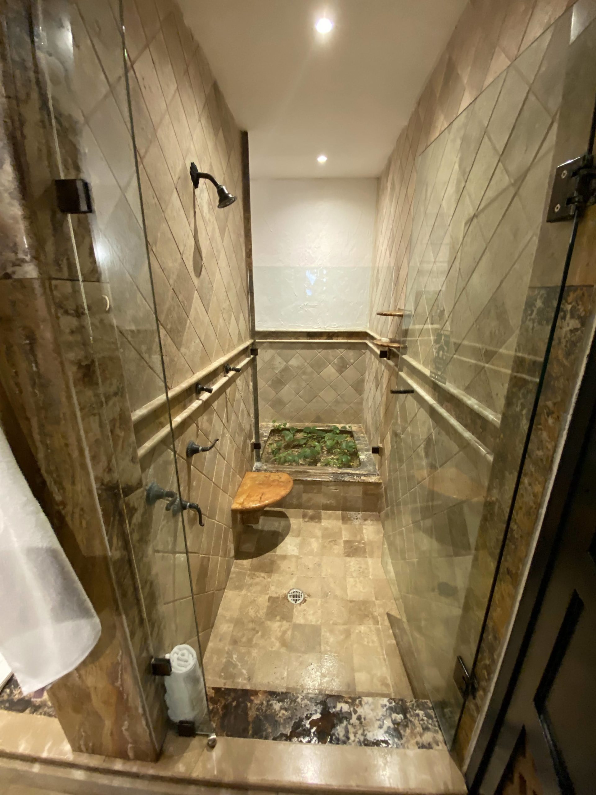 a shower with a seat and a seat