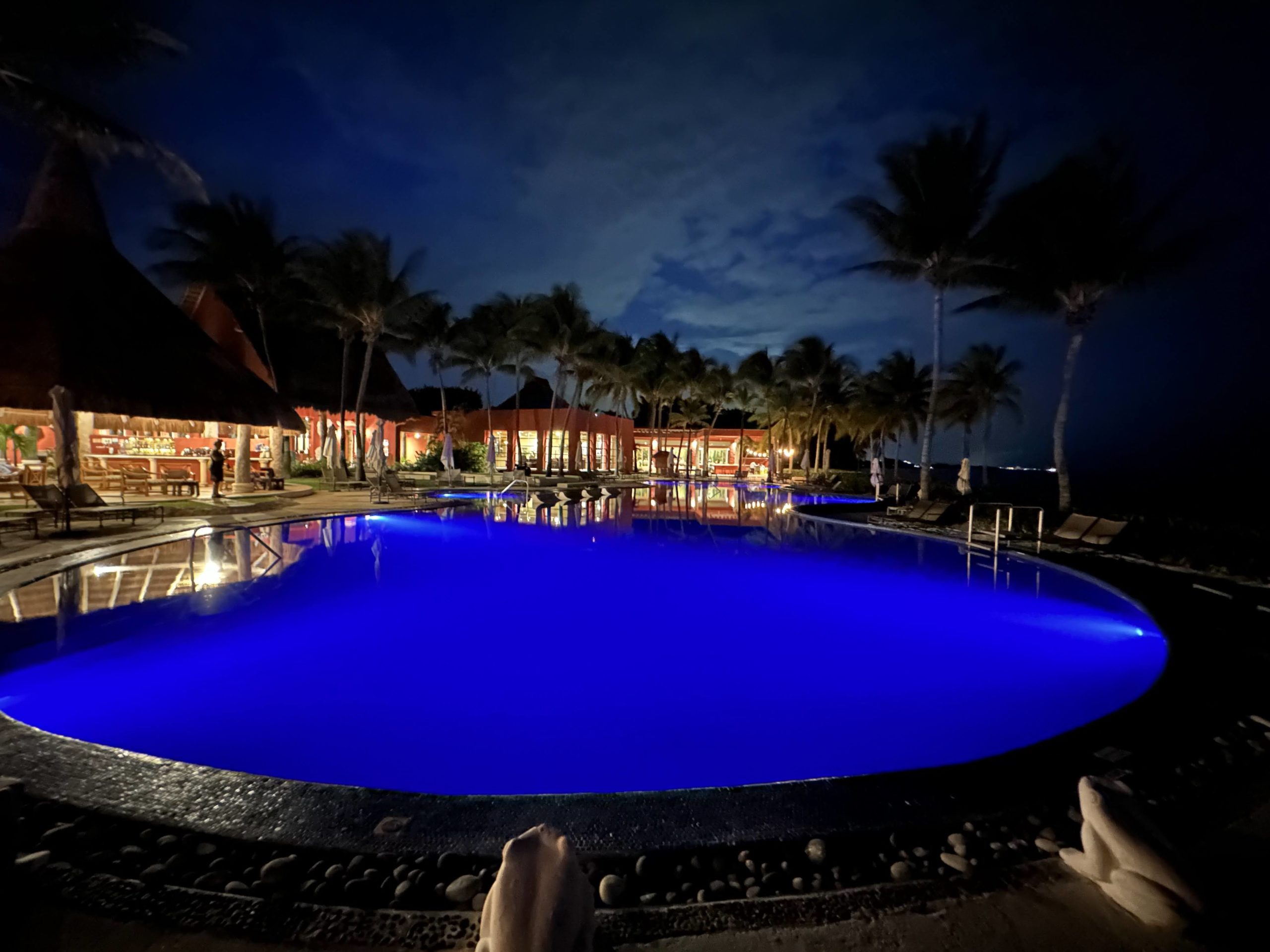 a pool with blue lights at night