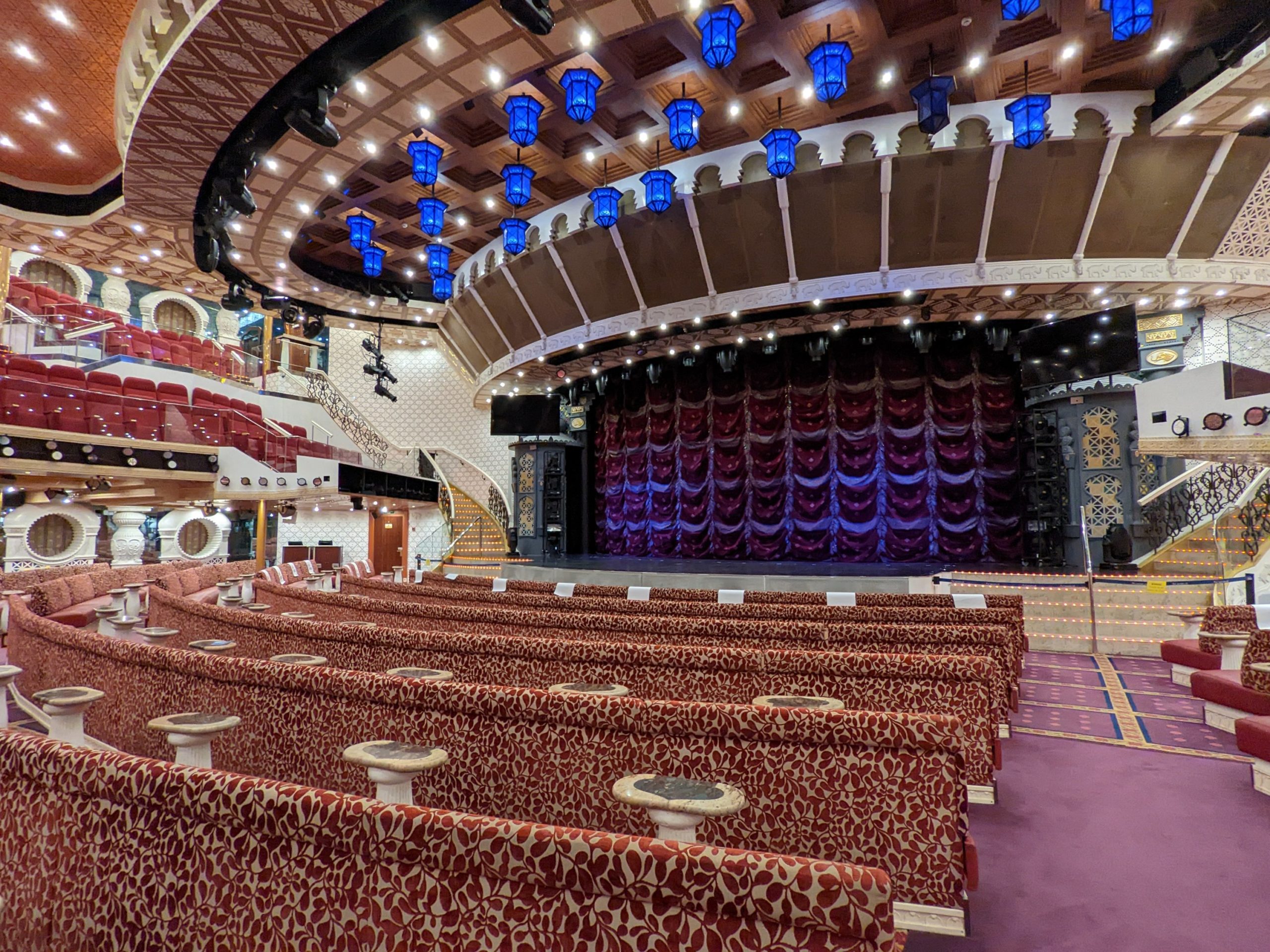 a theater with red and white seats and blue lights