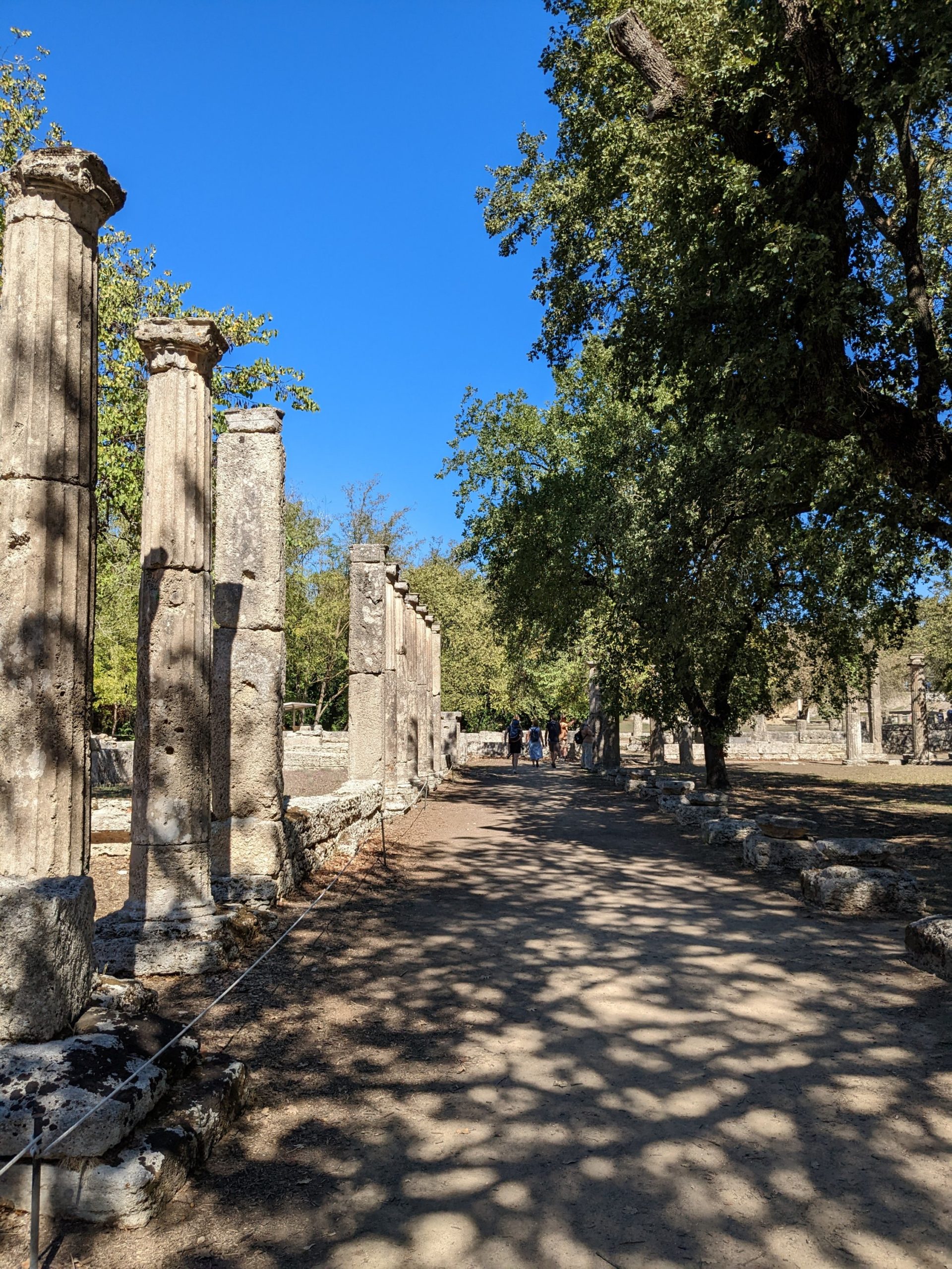a stone pillars lined up on a dirt path