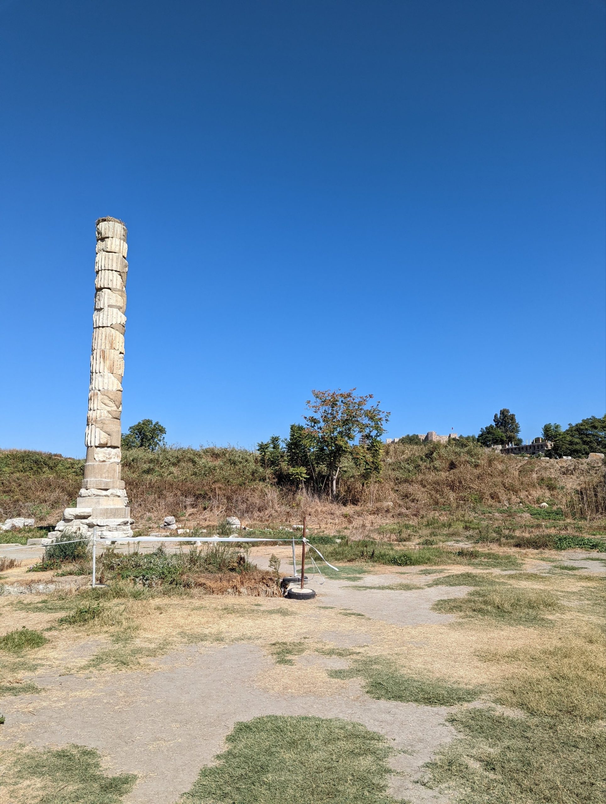 a stone pillar in a field