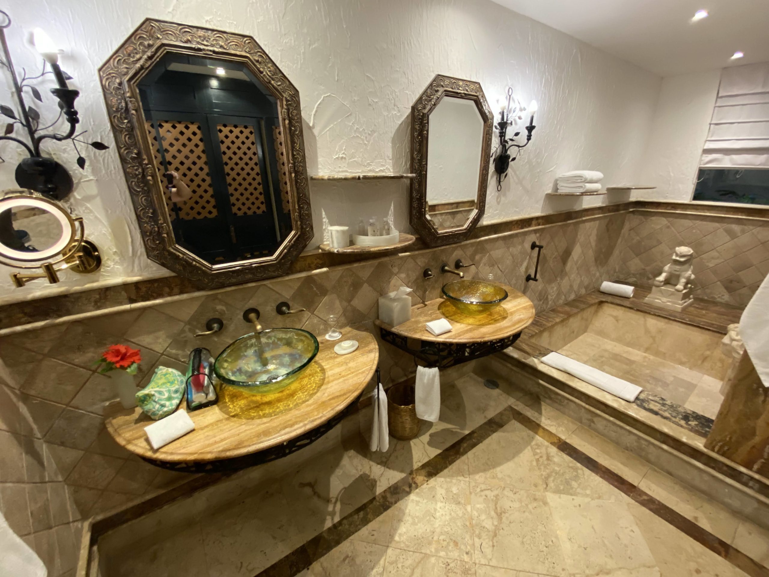 a bathroom with marble floor and mirrors