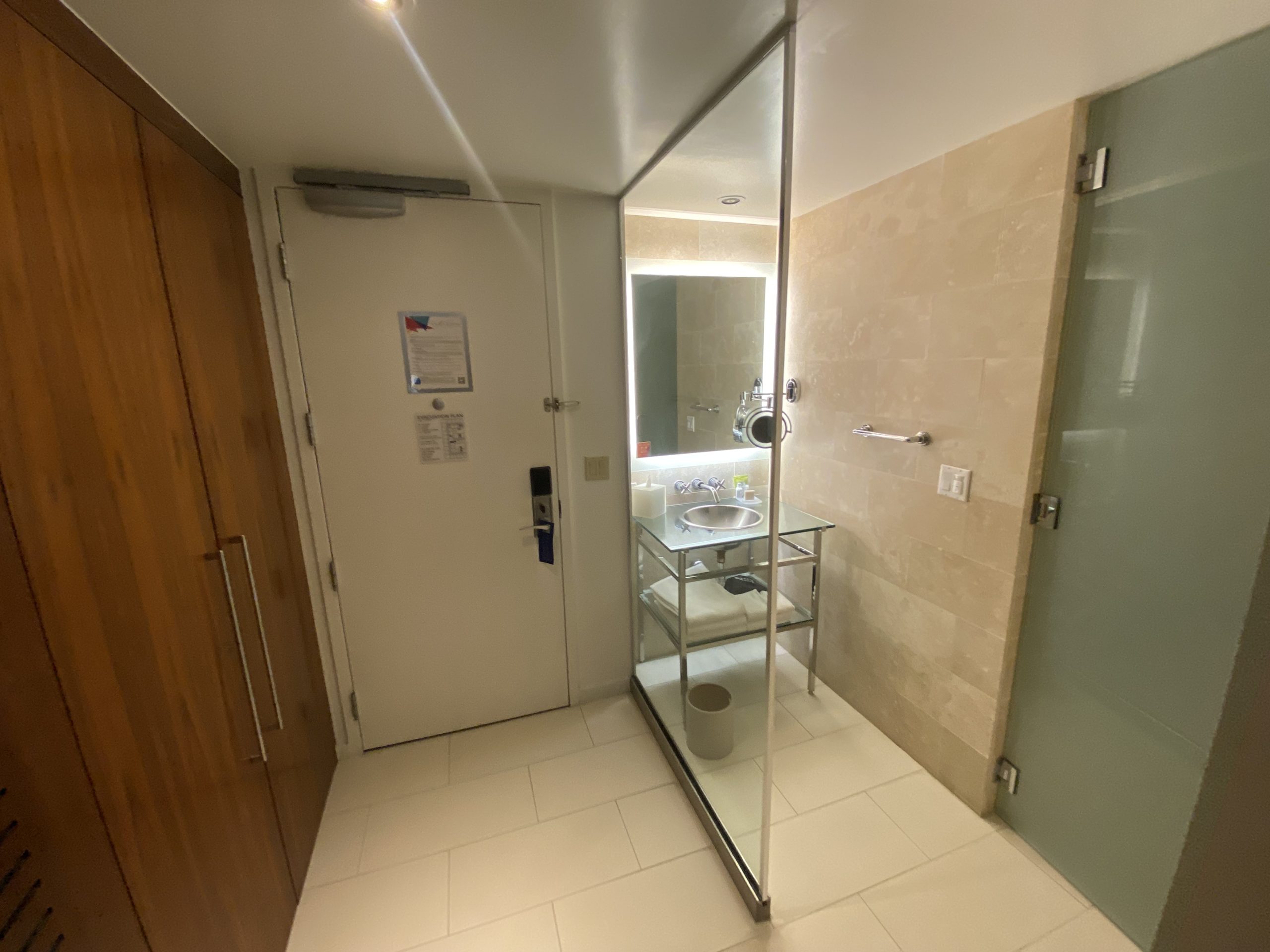 a bathroom with a glass shower door and a sink