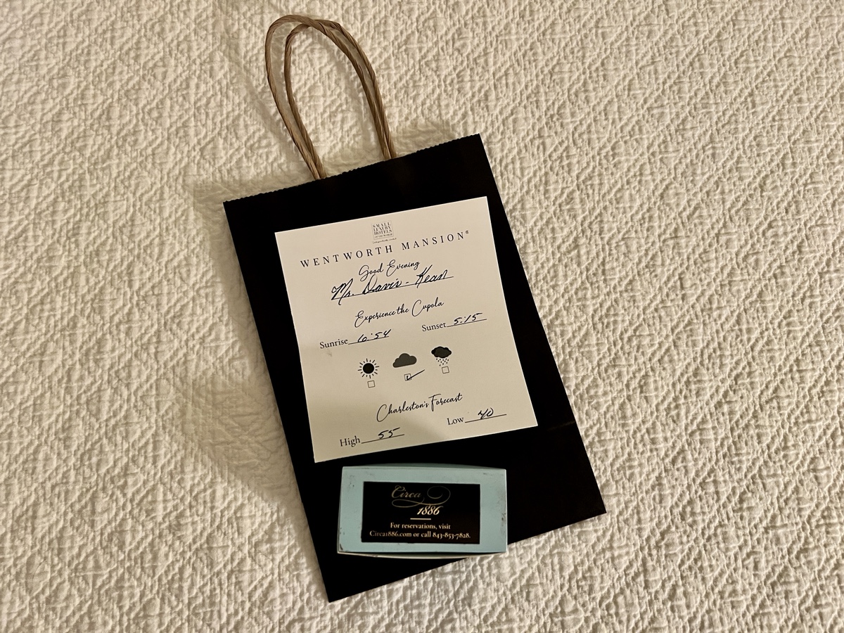 a black bag with a white paper and a blue business card