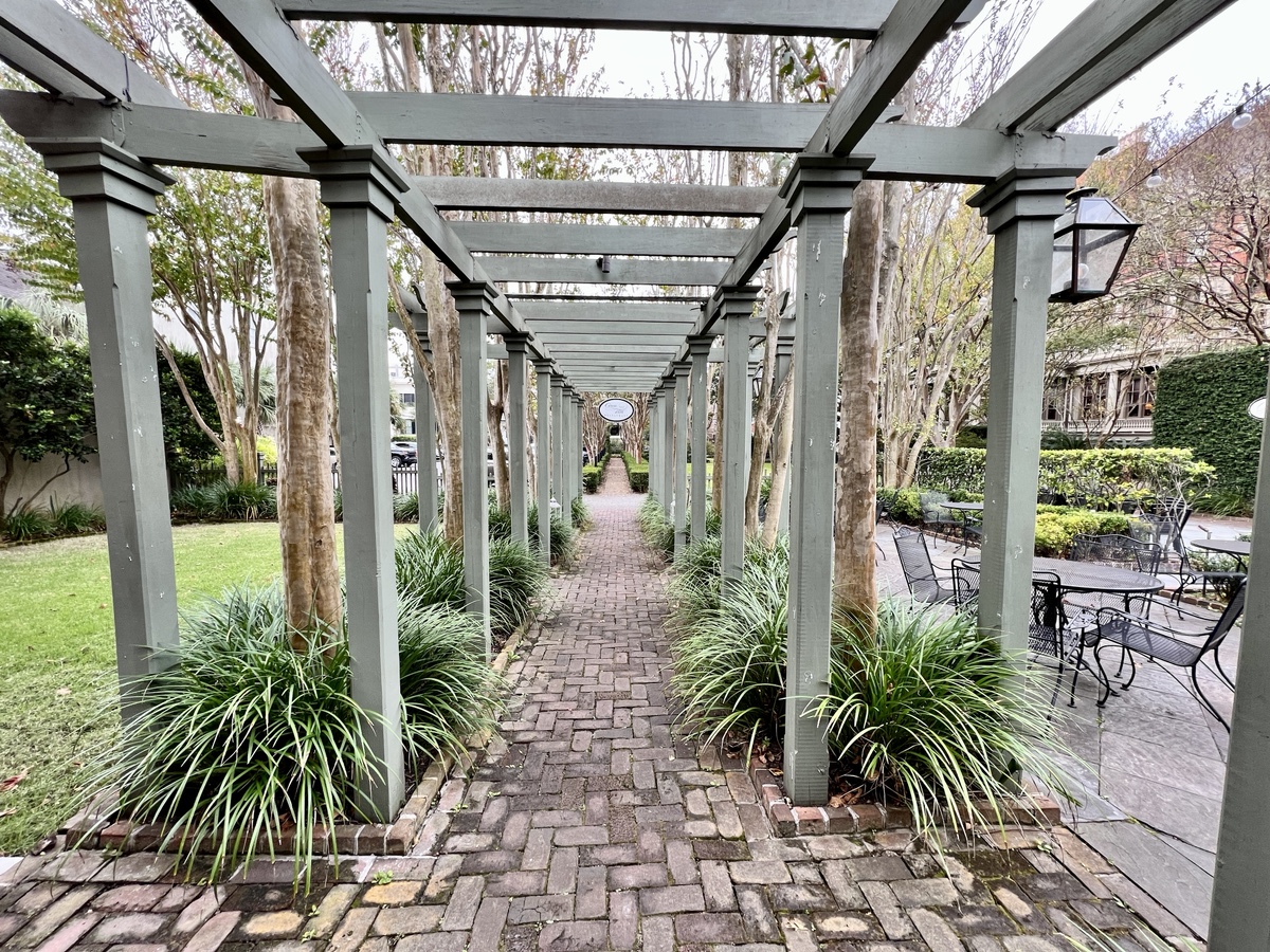 a walkway with a pergola