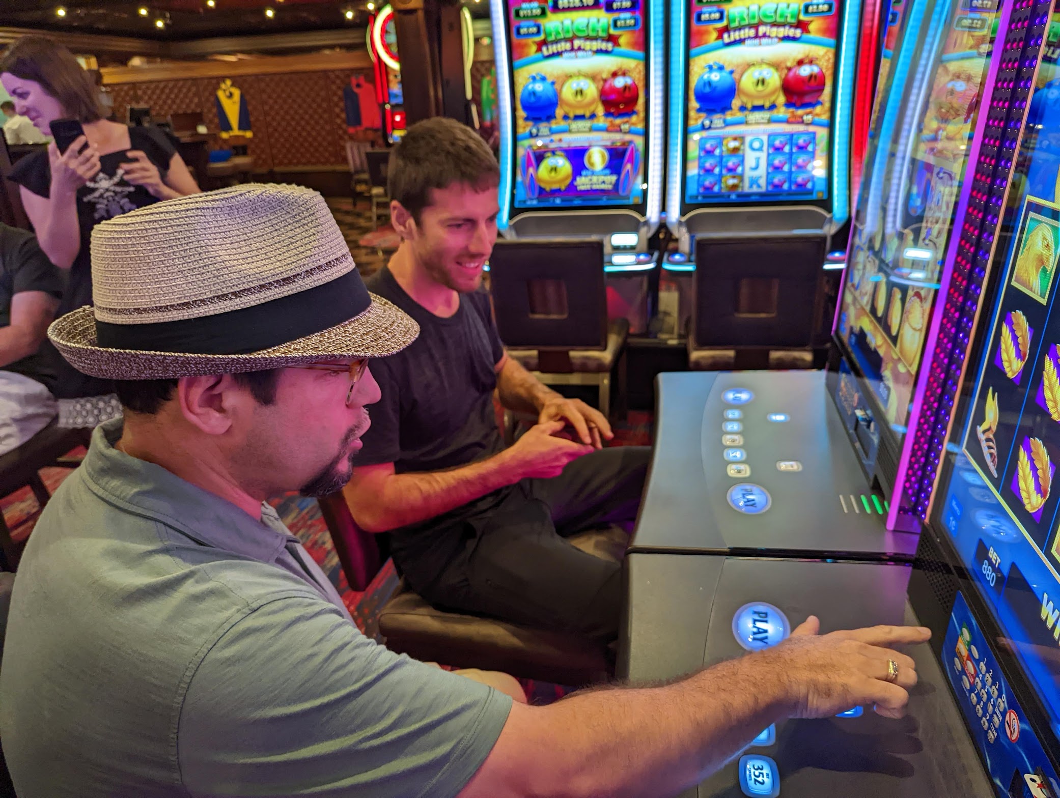 a group of men playing slot machines