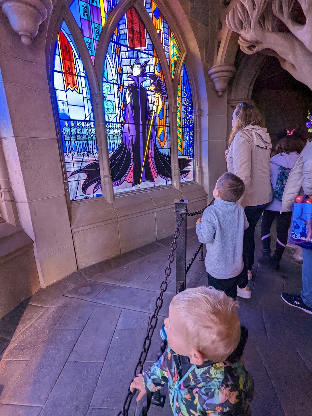 a group of kids looking at a stained glass window