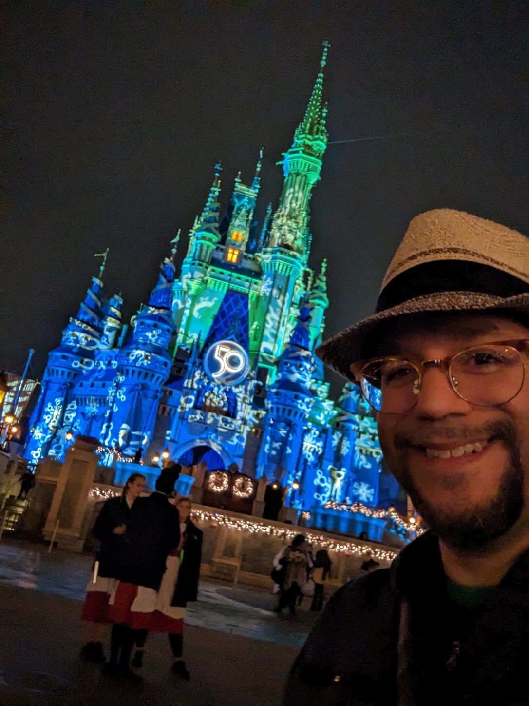 a man taking a selfie in front of a castle