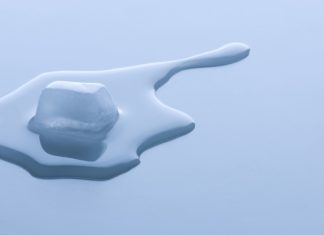 a melting ice cube on a white surface