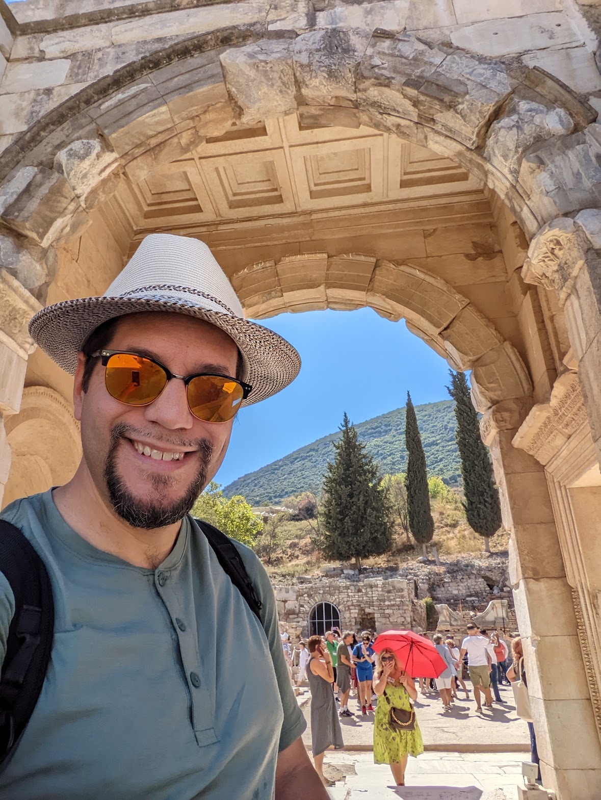 a man taking a selfie in a stone archway