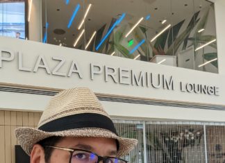 a man taking a selfie in front of a sign